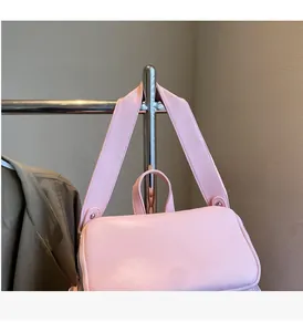 Detailed macro view of comfortable handles and wide straps on a pink vintage backpack