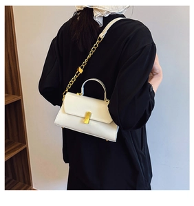 Rear view of model wearing white leather crossbody bag with golden chain and metal buckle