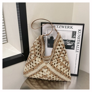 Macro shot of boho woven hobo bag showing intricate geometric crochet patterns and leather strap