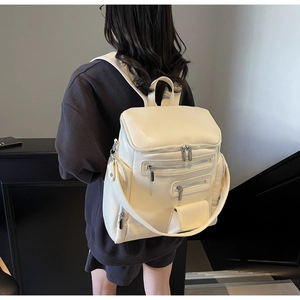 Side view of cream white large capacity backpack with multiple zipper compartments