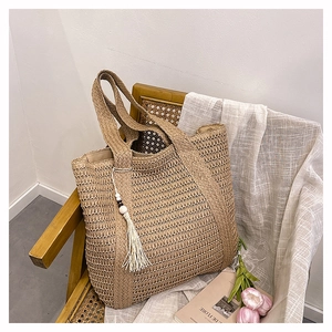 Detailed straw tote bag texture with elegant white rope tassel and summer resort vibes