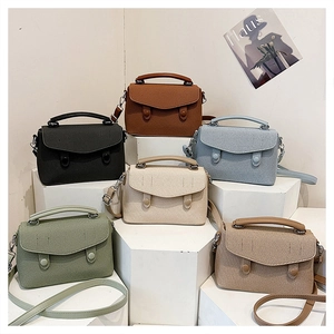 Detailed close-up of six-color vintage rectangular small square bags on white stands