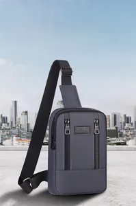 Detail of dark gray men's sport chest bag showing smooth matte texture and zip pockets