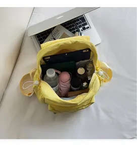 Detailed interior of yellow nylon backpack showing large storage for tablet and umbrella