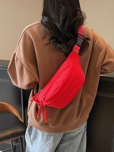 Red crescent canvas chest bag with double zippers and adjustable strap for women