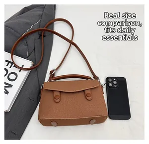 Brown textured small square bag size comparison with smartphone and daily essentials