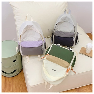 Detailed close-up of lightweight outdoor travel backpacks in three stylish color-block designs