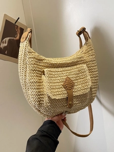 Handwoven straw shoulder bag with half-moon shape and brown leather strap for summer vacation