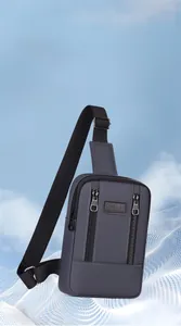 Detailed view of gray nylon crossbody bag with vertical zippers and sport branding