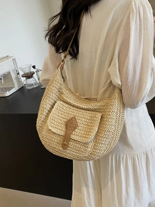 Beige woven straw shoulder bag with brown leather flap pocket for summer beach vacations