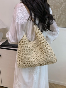 Hollow-out crochet shoulder bag in beige with brown leather straps for beach vacation