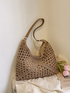 Large woven straw hobo bag with hollow diamond pattern and brown leather straps