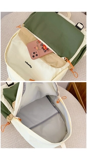 Detail view of multi-compartment interior with laptop sleeve and vibrant orange zipper pulls