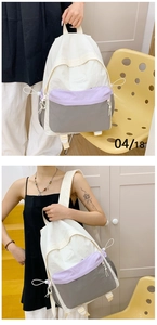 Detail of multi-color hiking backpack with lavender side pockets and drawstring
