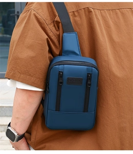 Detailed close-up of dark blue denim shoulder bag featuring SPORT logo and zipper pockets