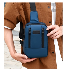 Detail of blue waterproof nylon sport chest bag with leather logo and adjustable strap
