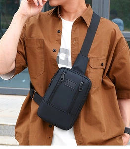 Detail of black sports chest bag with embossed SPORT label on durable matte fabric