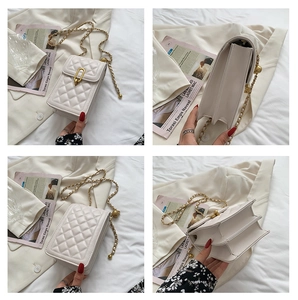 Detail showing white quilted leather phone bag with gold chain and dual compartments