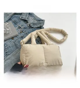 Détail macro du sac cabas matelassé beige montrant le rembourrage et la texture du tissu