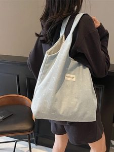 Light blue denim tote bag with white bow patterns for women's casual daily commute use