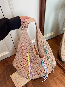 Beige crochet beach tote with colorful tassels and hollow mesh design for summer vacation