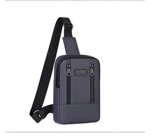 Detail view of denim texture, dual front zippers and Sport logo on blue crossbody bag