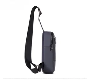 Side view of dark gray washed denim sling bag showing depth and zipper detail
