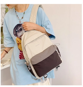 Side view of lightweight tricolor canvas backpack with adjustable straps and multi-pockets