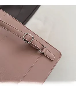 Detail of pink leather handbag showing silver buckle and precise stitching craft