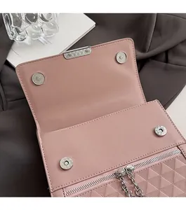Detail of pink quilted leather shoulder bag with magnetic snaps and silver chain
