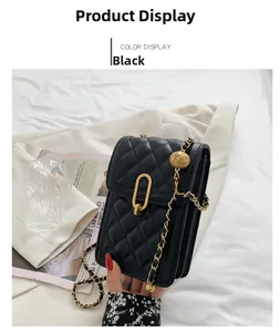 Detail of black quilted crossbody phone bag with gold hardware and chain strap