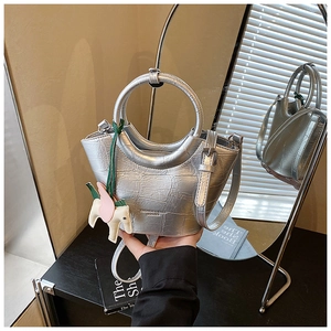 Silver crocodile embossed handbag with metal handle and decorative horse charm detail