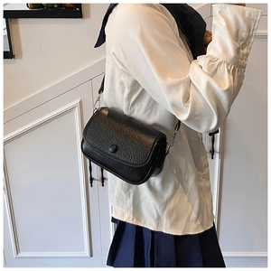Fashionable black crossbody bag for women with pebbled leather texture and metal buckle
