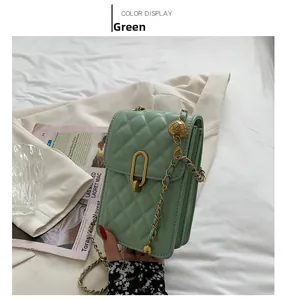 Detail of light green quilted mini bag with gold chain strap and metallic sphere charm