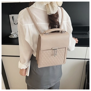 Beige PU leather backpack with geometric quilting and round silver zipper detail