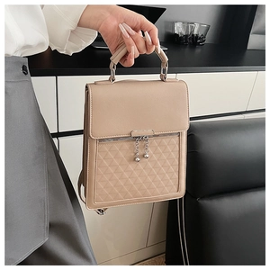 Detail of khaki PU handbag with geometric diamond pattern and metal ball zipper pull