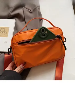 Practical back zipper pocket on an orange waterproof messenger bag for secure smartphone storage