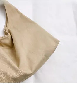 Close-up of light khaki twill fabric texture on a large capacity commuter tote bag
