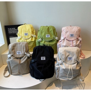 Detailed view of lightweight canvas backpacks in six colors with drawstring flap and side pockets
