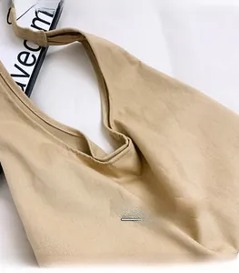 Detailed macro view showing the high-density twill canvas texture of this khaki tote bag