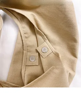 Detailed macro view of high-quality silver magnetic buckles on khaki canvas tote bag