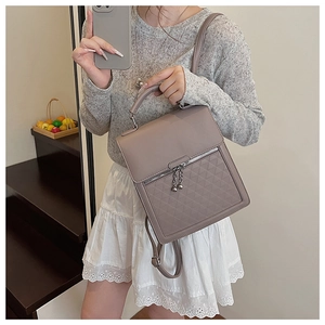 Detailed view of the gray-taupe PU leather backpack with geometric quilted patterns