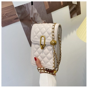 Detail of white quilted leather phone bag featuring adjustable gold bead on chain strap