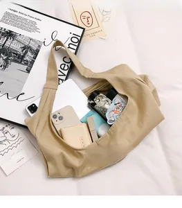 Detail view of khaki canvas tote bag interior showing spacious storage for tablet and phone