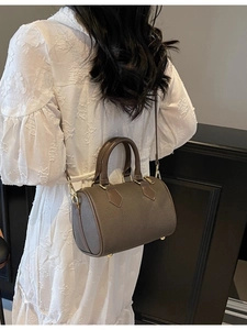 Taupe pebbled leather Boston bag with gold hardware and removable shoulder strap