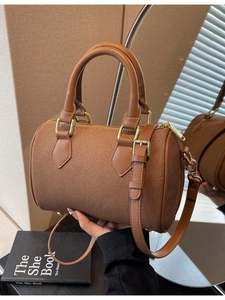 Brown woven texture Boston barrel handbag with leather handles and gold metal hardware