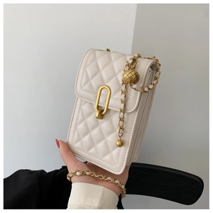 Detail of beige quilted mini square bag with golden chain and adjustable metal ball