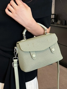 Elegant light green woven crossbody bag with top handle and adjustable shoulder strap