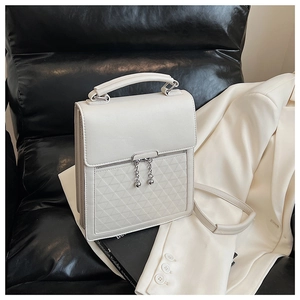 Detail of a minimalist cream white PU leather handbag with elegant geometric stitching