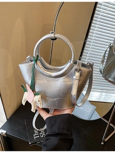 Silver metallic crocodile pattern basket bag with round handles and shoulder strap